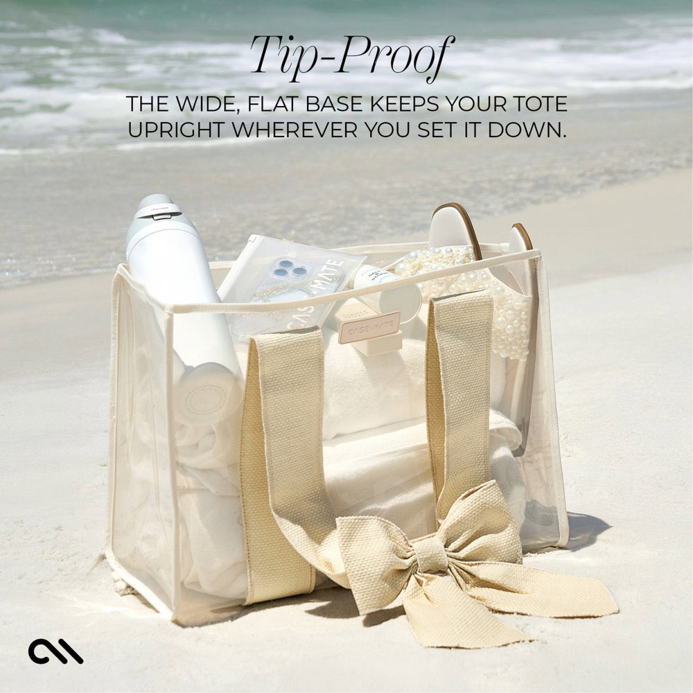 TIP-PROOF. THE WIDE FLAT BASE KEEPS YOUR TOTE UPRIGHT WHENEVER YOU SET IT DOWN #color_ecru raffia bow